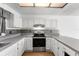Bright kitchen features white cabinets, stainless steel appliances, and subway tile backsplash at 1189 Rib Ave, St Cloud, FL 34771