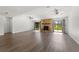 Spacious living room with stone fireplace, two ceiling fans, and sliding doors to the backyard at 1189 Rib Ave, St Cloud, FL 34771