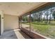 Relaxing screened porch offering views of the lush, green backyard at 1189 Rib Ave, St Cloud, FL 34771