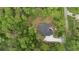 Aerial view of a home surrounded by lush green trees at 1394 Kettledrum Trl, Deltona, FL 32725