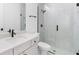 Modern bathroom featuring white vanity, quartz countertop, and frameless shower with tiled walls at 1394 Kettledrum Trl, Deltona, FL 32725