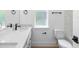 Bright modern bathroom with dual sinks, quartz countertops and black fixtures, ample natural light at 1394 Kettledrum Trl, Deltona, FL 32725