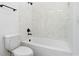 Clean white bathroom featuring white tile surround with black fixtures at 1394 Kettledrum Trl, Deltona, FL 32725