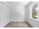 Bright bedroom with neutral carpet, a window, and a closet with sliding doors at 1394 Kettledrum Trl, Deltona, FL 32725