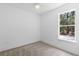 Bedroom with neutral carpet, ceiling fan, and a window with natural light at 1394 Kettledrum Trl, Deltona, FL 32725