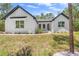 Charming white exterior with black trim, modern windows, and walkway to front door at 1394 Kettledrum Trl, Deltona, FL 32725