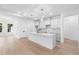 Modern kitchen with white cabinetry, stone countertops, and stainless steel appliances is move-in ready at 1394 Kettledrum Trl, Deltona, FL 32725