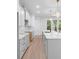 Modern kitchen featuring white cabinets, stainless steel appliances, and stylish countertops at 1394 Kettledrum Trl, Deltona, FL 32725