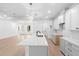 Bright kitchen featuring white cabinets, a center island, and sleek countertops in an open space at 1394 Kettledrum Trl, Deltona, FL 32725