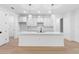 Modern white kitchen with quartz countertop island, pendant lighting, and stainless steel faucet at 1394 Kettledrum Trl, Deltona, FL 32725