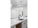Bright kitchen featuring white countertops, stainless steel sink, and modern pendant lighting at 1394 Kettledrum Trl, Deltona, FL 32725