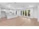 Open-concept kitchen and living area with sleek finishes and a seamless flow to outdoor space at 1394 Kettledrum Trl, Deltona, FL 32725