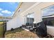 Cozy backyard with a patio, grill, black metal fence, and well-maintained privacy fence at 1401 Mirabella Cir, Davenport, FL 33897