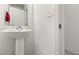 Bathroom featuring a pedestal sink, mirror, and light switches at 1401 Mirabella Cir, Davenport, FL 33897