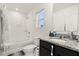 Bright bathroom featuring a shower over tub, window, and granite vanity at 1401 Mirabella Cir, Davenport, FL 33897