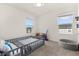 Bright ' bedroom with a gray carpet, two windows, and a toy corner at 1401 Mirabella Cir, Davenport, FL 33897