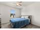 Well-lit bedroom featuring a ceiling fan, a window, and a bed at 1401 Mirabella Cir, Davenport, FL 33897