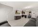 Spacious living room showcasing tile floors, a sectional sofa, a mounted television and dark wood cabinets at 1401 Mirabella Cir, Davenport, FL 33897
