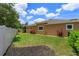 A spacious backyard features green grass and tasteful landscaping with a white fence boundary at 14830 Winkfield Ct, Winter Garden, FL 34787