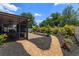 Well-manicured backyard with a covered patio, landscaped beds, and a brick paver patio at 14830 Winkfield Ct, Winter Garden, FL 34787