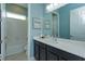Bright bathroom featuring blue walls, a white countertop, and a tub/shower combination at 14830 Winkfield Ct, Winter Garden, FL 34787