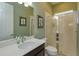 Well-lit bathroom with a glass door shower, white countertop and framed art at 14830 Winkfield Ct, Winter Garden, FL 34787