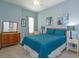 Comfortable bedroom features blue accents, wood furniture, and ample natural light at 14830 Winkfield Ct, Winter Garden, FL 34787