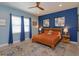 Comfortable bedroom boasts hardwood floors, abundant natural light, and a relaxing color palette at 14830 Winkfield Ct, Winter Garden, FL 34787