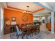 Dining room with a large table, modern lighting, views into the kitchen and living areas for easy entertaining at 14830 Winkfield Ct, Winter Garden, FL 34787