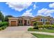 Charming one-story home features a beautifully paved driveway, well-manicured landscaping, and a welcoming entryway at 14830 Winkfield Ct, Winter Garden, FL 34787