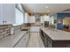 Open concept kitchen features white cabinets, stainless appliances, and a large island with counter seating at 14830 Winkfield Ct, Winter Garden, FL 34787