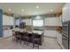 Spacious kitchen features a large center island with seating, tiled backsplash, and stainless steel appliances at 14830 Winkfield Ct, Winter Garden, FL 34787