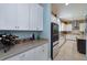 Bright kitchen with an oversized island, modern appliances, white cabinetry, and subway tile backsplash at 14830 Winkfield Ct, Winter Garden, FL 34787