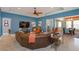 Spacious living room with comfortable seating, large television, and an open layout connecting to other living areas at 14830 Winkfield Ct, Winter Garden, FL 34787