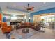 Open living area features a modern ceiling fan, lots of seating, and open access to the kitchen and outdoor living at 14830 Winkfield Ct, Winter Garden, FL 34787