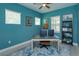 Home office provides ample workspace, natural light, and a comfortable seating area at 14830 Winkfield Ct, Winter Garden, FL 34787