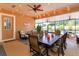 Inviting enclosed patio with outdoor seating, dining area, ceiling fans, and backyard access at 14830 Winkfield Ct, Winter Garden, FL 34787