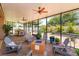 Spacious screened patio with fire pit, seating, brick flooring, and view of landscaped yard at 14830 Winkfield Ct, Winter Garden, FL 34787