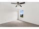 The bedroom has neutral carpet, a ceiling fan, and a window overlooking the neighborhood at 14927 Faversham Cir, Orlando, FL 32826