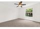 Bedroom with a ceiling fan and a bright window, carpeted floor, and white walls at 14927 Faversham Cir, Orlando, FL 32826