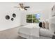 Bright bedroom with a ceiling fan and large window with view of tropical landscaping at 14927 Faversham Cir, Orlando, FL 32826