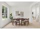 Sunlit dining area features a contemporary table set and neutral decor at 14927 Faversham Cir, Orlando, FL 32826