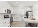 Beautiful kitchen featuring white cabinets, a stylish backsplash, stainless steel appliances, and a central island at 14927 Faversham Cir, Orlando, FL 32826