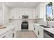 Modern kitchen with white cabinets, stainless steel appliances, and stylish backsplash, offering a clean design at 14927 Faversham Cir, Orlando, FL 32826
