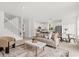 Bright open-plan living area features light wood floors and modern decor at 14927 Faversham Cir, Orlando, FL 32826