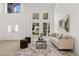 Spacious living room with tall windows and stylish, modern furniture at 14927 Faversham Cir, Orlando, FL 32826