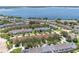 An aerial view of lakefront community homes surrounded by trees at 152 Riggings Way, Clermont, FL 34711