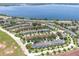 Lakefront aerial view of homes, surrounded by lush greenery at 152 Riggings Way, Clermont, FL 34711