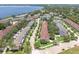 Aerial view of a residential community next to a lake at 152 Riggings Way, Clermont, FL 34711