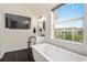 Bright bathroom featuring a tub, single vanity, and outside view at 152 Riggings Way, Clermont, FL 34711